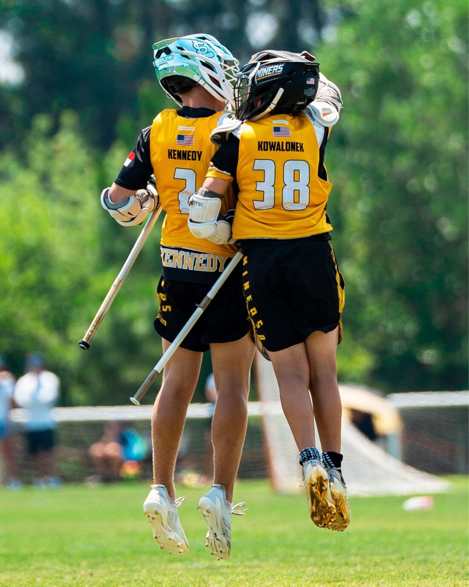 Two Carolina Miners players celebrating mid-air after a goal.